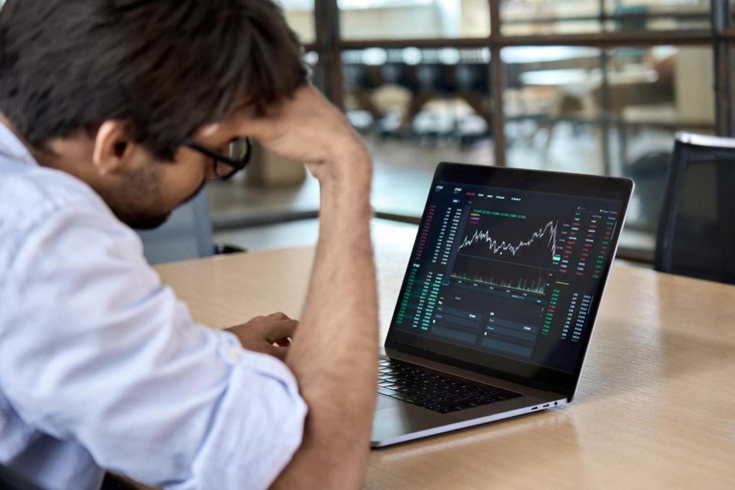 Analyst reviewing trading charts on a laptop, illustrating financial risk in Dubai